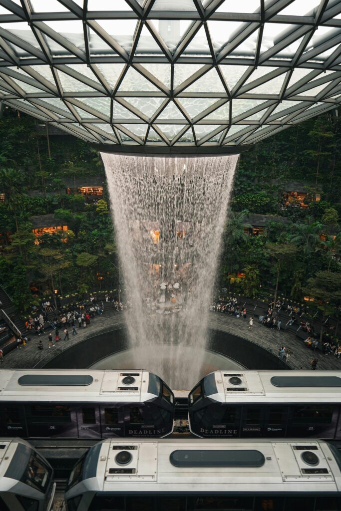Modern architectural marvel featuring the iconic indoor waterfall at Jewel Changi Airport, Singapore.