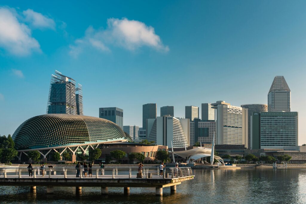 Vibrant Singapore skyline showcasing the iconic Esplanade Theatre and cityscape under a clear blue sky.